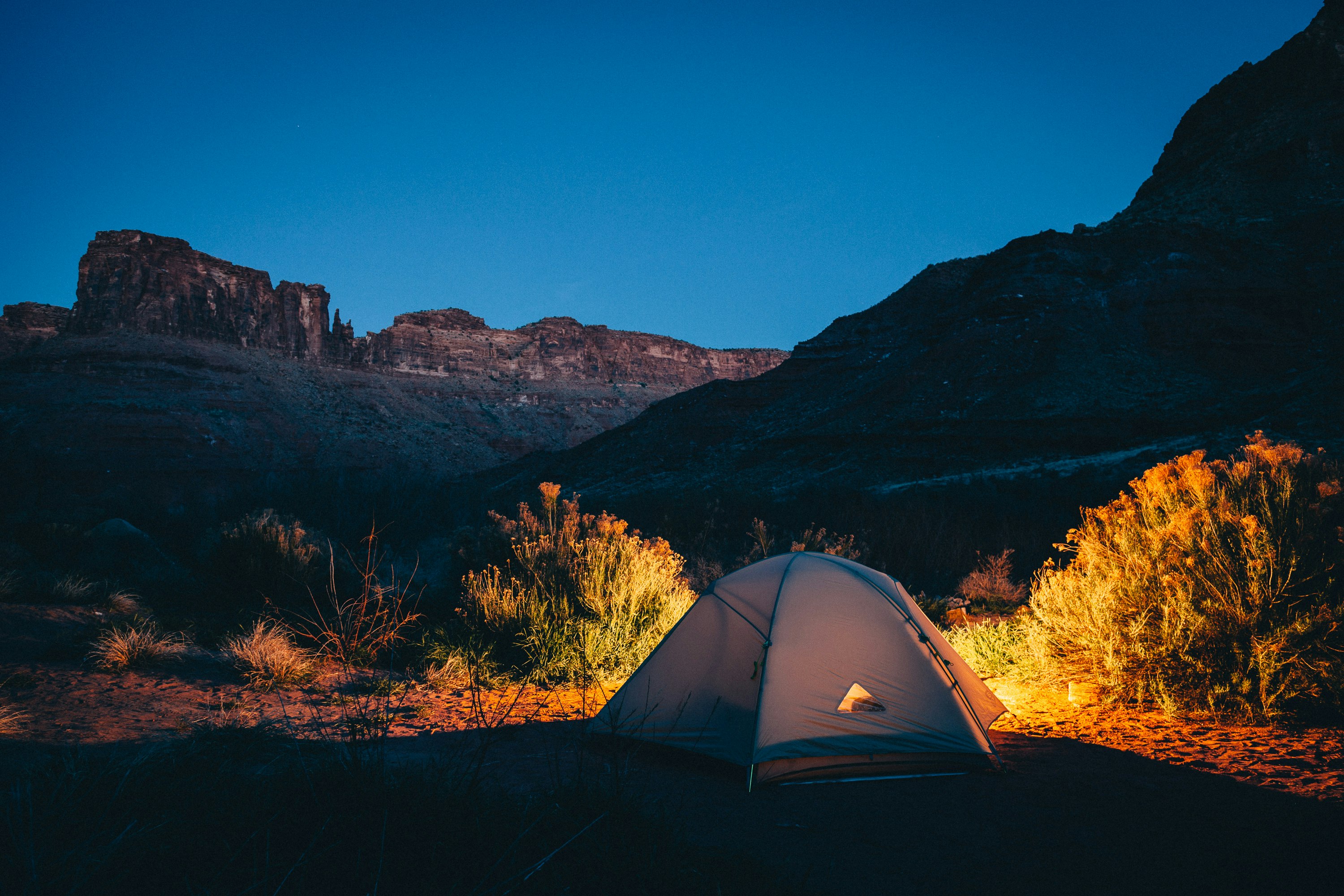 white camping tent beside mountain